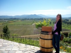 Posing with a Pinot Noir Vine and the vineyard in the background!