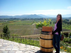 Posing with a Pinot Noir Vine and the vineyard in the background!